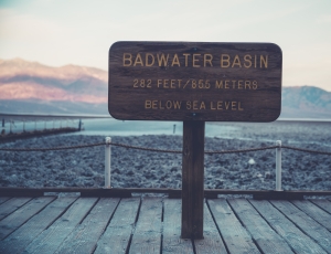 badwater basin signage on brown wooden hallway thumbnail